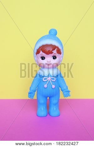 Cute vintage Japanese blue plastic doll on pastels color background.