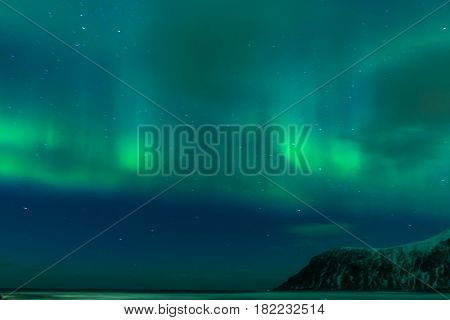 Aurora Borealis Known as Nother Lights Playing with Vivid Colors Over Lofoten Islands in Norway. Horizontal Image Orientation