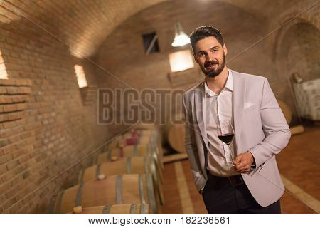 Oenologist tasting wines in wine grower cellar