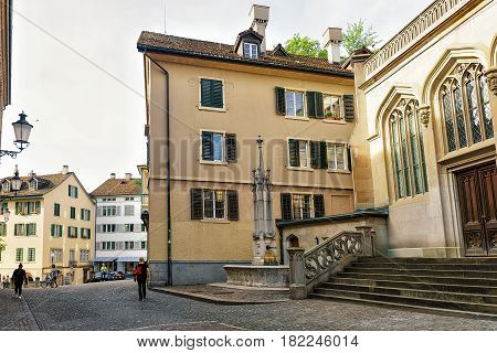 Zurich, Switzerland - September 2, 2016: Fountain at Helferei on Zwingliplatz square in Zurich old town Switzerland. People on the background