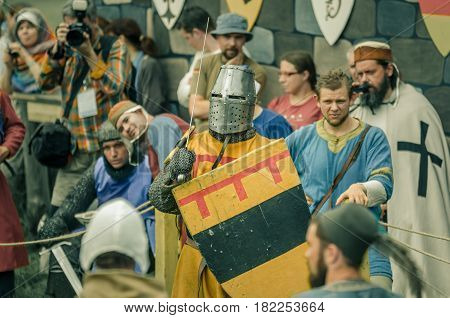 RITTER WEG MOROZOVO APRIL 2017: Festival of the European Middle Ages. Medieval joust knights in helmets and chain mail battle on swords with shields in their hands.