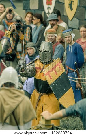 RITTER WEG MOROZOVO APRIL 2017: Festival of the European Middle Ages. Medieval joust knights in helmets and chain mail battle on swords with shields in their hands.