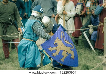 RITTER WEG MOROZOVO APRIL 2017: Festival of the European Middle Ages. Medieval joust knights in helmets and chain mail battle on swords with shields in their hands.