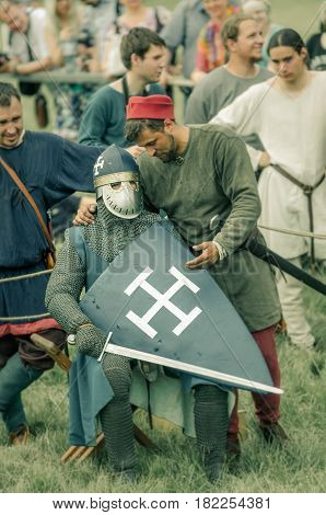 RITTER WEG MOROZOVO APRIL 2017: Festival of the European Middle Ages. Medieval joust knights in helmets and chain mail battle on swords with shields in their hands.