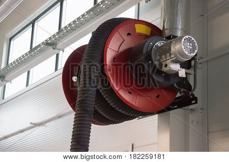 Close-up photo of the rd automobile fumes extractor in the car service station