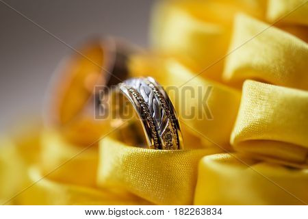 diamond ring on yellow flower. wedding rings together. selective focus.