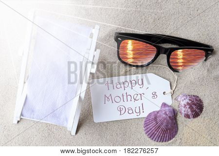 Sunny Summer Label With English Text Happy Mothers Day. Flat Lay View. Summer Decoration With Deck Chair, Seashells And Sunglasses. Greeting Crad With Sand Background
