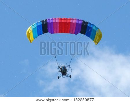 Powered paragliding (paramotoring) in low flight in a cloud of poplar fluff