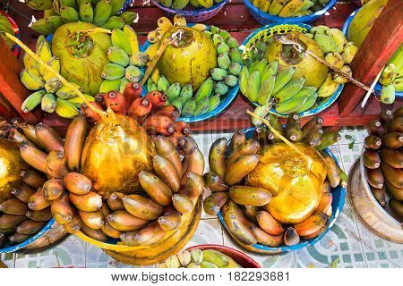 Baskets of green bananas and coconuts for donation in Botataung Pagoda, Yangon, Myanmar (Burma)