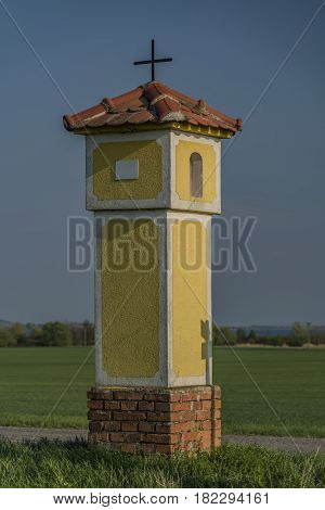 Yellow chapel near Strachotin village in spring sunny evening