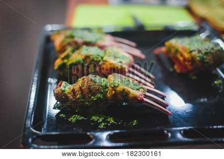 Different stages of cooking the steak on a kitchen, barbeque, roasted lamb ribs, big dish plate with roasted full pork head, served in restaurant with vegetables, lamb, ham and chicken.