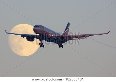 SHEREMETYEVO, MOSCOW REGION, RUSSIA - NOVEMBER 29, 2013: Aeroflot Airbus A330 VQ-BBF crossing the moon before landing at Sheremetyevo international airport.