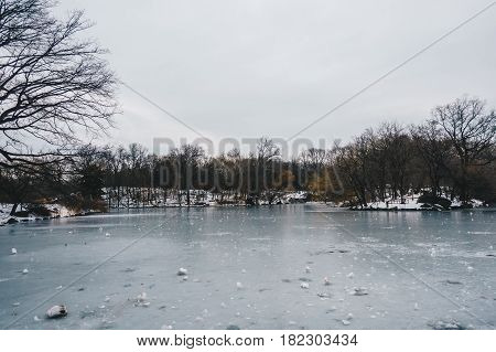 Central Park Boathouse and iced lake in New York City USA