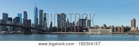 View of Brooklyn Bridge and Manhattan skyline WTC Freedom Tower from Dumbo Brooklyn. Brooklyn Bridge is one of the oldest suspension bridges in the USA