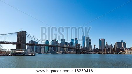View of Brooklyn Bridge and Manhattan skyline WTC Freedom Tower from Dumbo Brooklyn. Brooklyn Bridge is one of the oldest suspension bridges in the USA