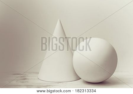 Simple geometric shapes cone and sphere. Elementary construction in art school.