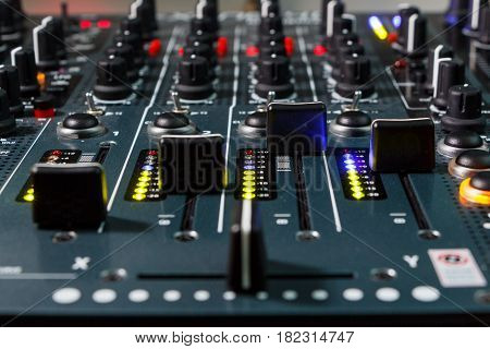 Close up shot of a DJ mixer volume faders