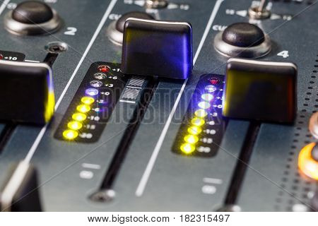 Close up shot of a DJ mixer volume faders