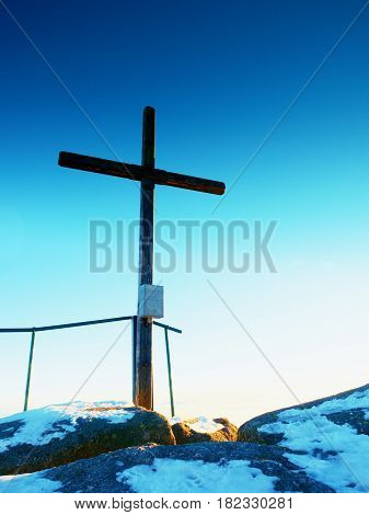 Modest Wooden Cross On Rocky Summit. Memory Of Victims