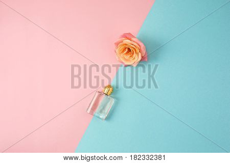 Cosmetics - Perfume on colorful backgroundb with rose