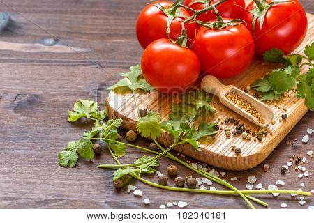 Ingredients for cooking sauce. Sprig of tomatoes parsley garlic mushrooms pepper pots mustard seeds.