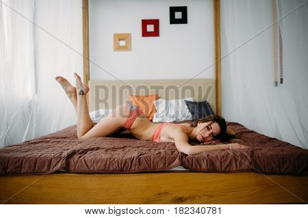 Hot Slim Brunette Lady In Beautiful Lingerie Lying On The Bed At Home In The Early Morning, Indoor P