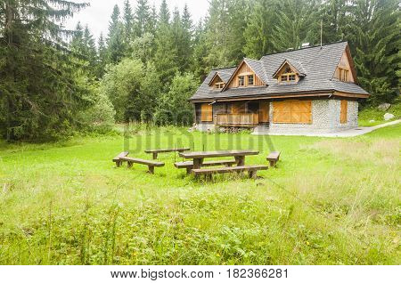 Podbanske Slovakia - August 16 2014: Cottage and a place to sit by the fire in the glade among the forest.