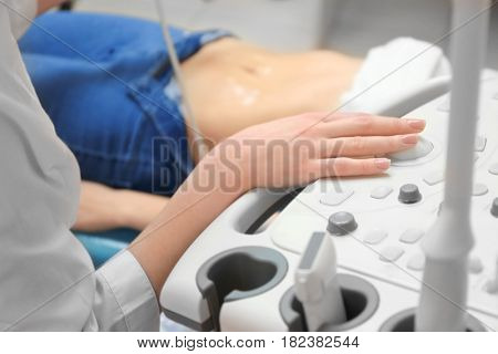 Young woman undergoing ultrasound scan in modern clinic