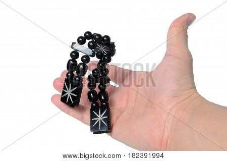 Rosary in hand on a white background isolated.