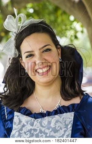 CAGLIARI, ITALY - May 29, 2016: Sunday at La Grande Jatte VIII Ed. At the Public Gardens - portrait of a beautiful smiling woman in Victorian costumes - Sardinia