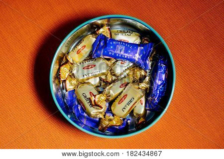 PARIS FRANCE - APR 9 2017: Mix of Griliaj and Chisinaul de Seara from BUCURIA candy factory fromRepublic of Moldova against red textile background