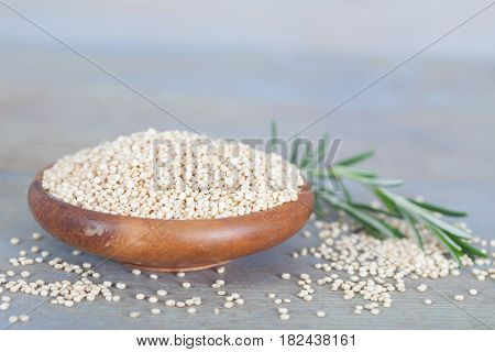 Wooden bowl full of healthy white quinoa seeds. Healthy vegan food.