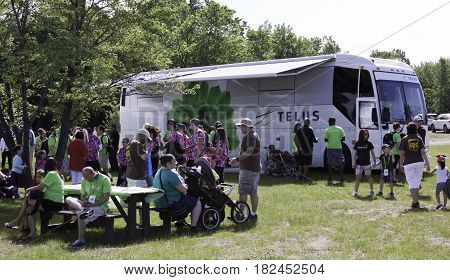 Laval, Quebec - June 14, 2015 - Landscape view of the Telus Tech Bus and a crowd of people checking it out at the 