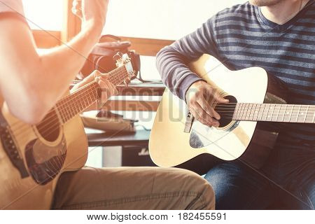 Masterclass learning to play the guitar outdoors. Musical education.