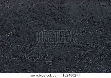 Black particleboard. Background image of chipboard. Simply texture