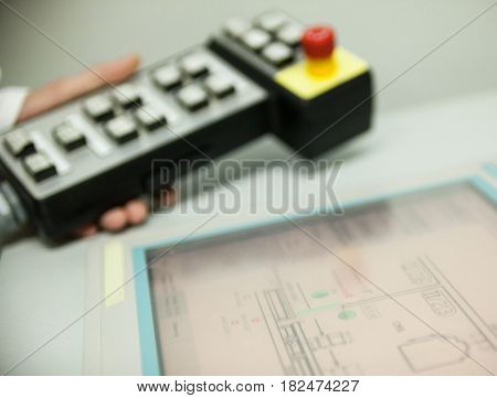 Male hand holding the control panel near the touchscreen. Close-up.