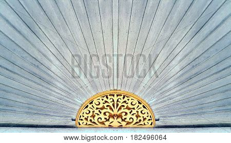 Wood carving pattern over the door of ancient Chinese style house at Trok Ban Chin Tak province Thailand