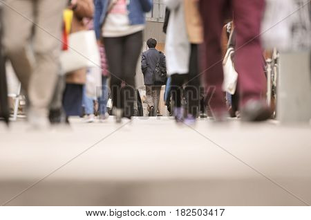 City business people walking in the commercial street, background focus of the man walking and blurred motion foreground, vintage color tone