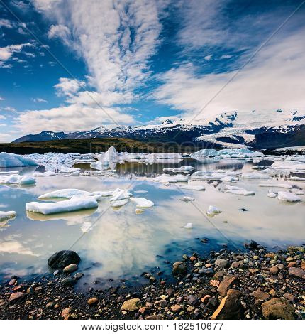 Floating ice box on the Fjallsarlon glacial lagoon. Sunny morning in Vatnajokull National Park southeast Iceland Europe. Artistic style post processed photo.