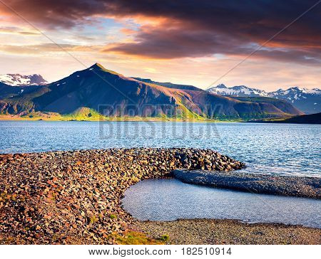 Dramatic sammer morning in the Icelandic fjords. Colorful sunrise near the small town Grundarfjordur Snaefellsnes peninsula Iceland Europe. Artistic style post processed photo.