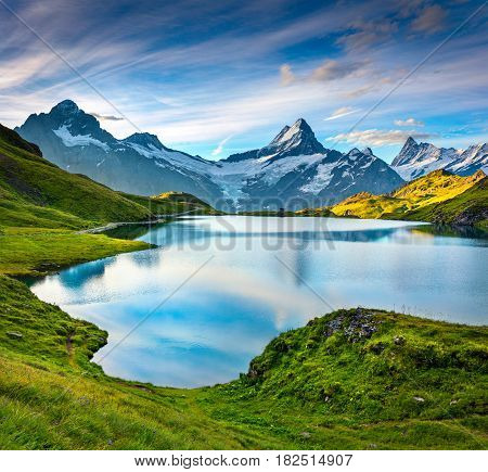 Wetterhorn and Wellhorn peaks over Bachsee lake. Colorful summer scene in Bernese Oberland Alps Grindelwald location Innertkirchen Switzerland Europe.