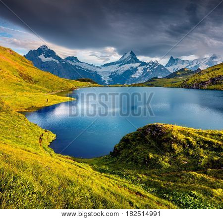 Wetterhorn and Wellhorn peaks over Bachsee lake. Colorful summer scene in Bernese Oberland Alps Grindelwald location Innertkirchen Switzerland Europe.