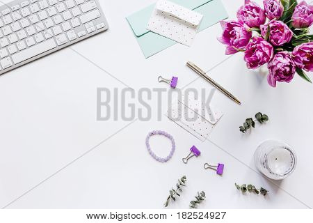 Trendy spring design of office workdesk with blossom on white background top view mock-up