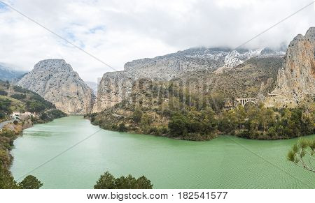 Panorama of Caminito del Rey. Lake with green water placed in the hills. El Chorro Malaga Spain