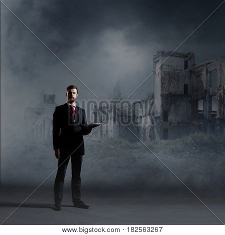 Businessman standing over apocalyptic background. Crisis, default, setback concept.