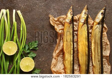 Fish saury smoked paper and the brown concrete background