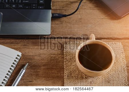Coffee Cup And Notebook On Wood Table