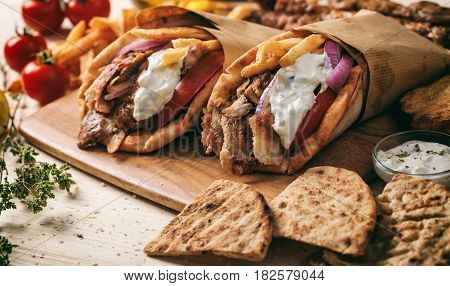 Greek Gyros Wrapped In Pita Breads On A Wooden Table