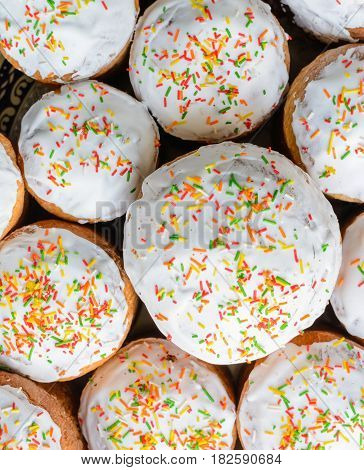 A Lot Of Easter Cakes With Sugar Icing And Colored Ornaments.