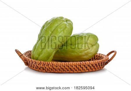 Chayote chokos in basket on white background